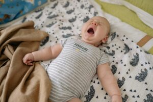 why do babies cry in their sleep